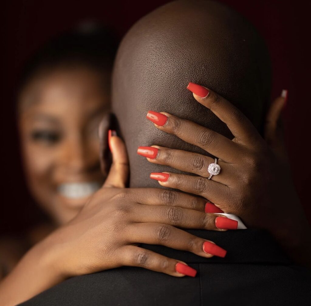 Ghanaian bride with her groom and wedding ring in focus